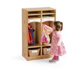 A toddler is hanging up her jacket in a cubby