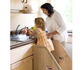 A child stands on the Toddler Step Stool to access a sink, with a teacher assisting her