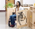 A woman sitting in a wheelchair is coming through a Roomscapes gateway