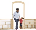 A teacher and a child are stepping through a Roomscapes Entry