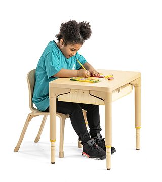 a child coloring at a table