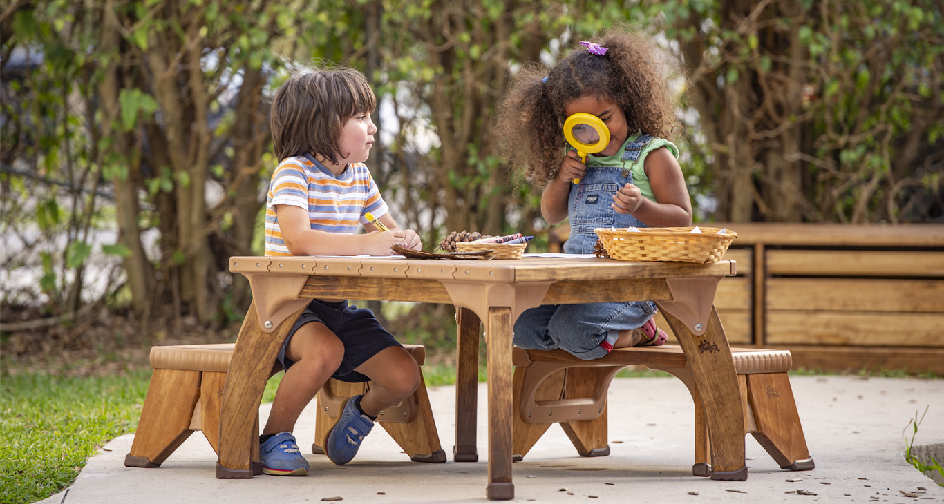 Children playing on an Outlast Play table