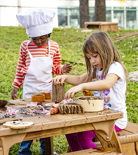 Children playing with an Outlast table