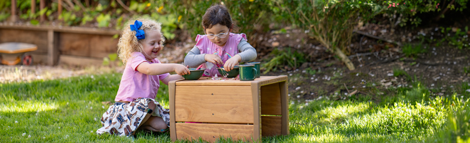 Two children playing with Outlast Cube table