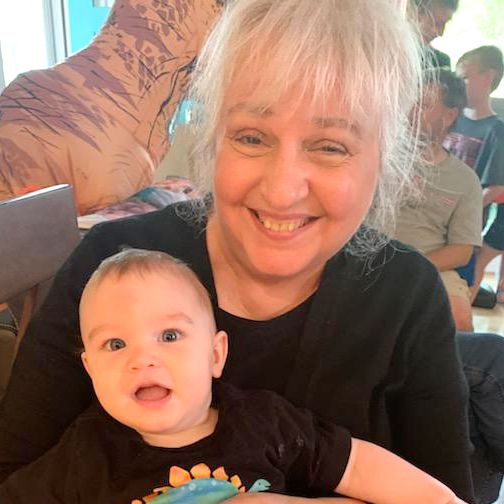 Portrait of Rae Pica holding a small child