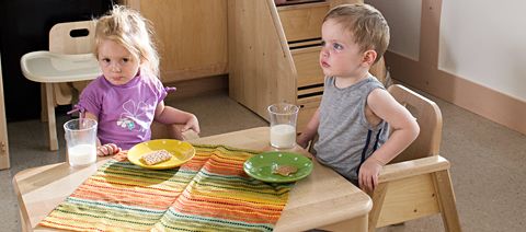 two children eating at a table