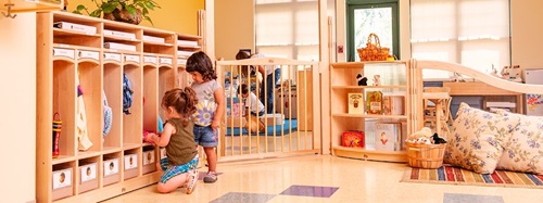 two children putting things in lockers