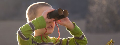 child looking through binoculars