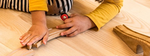 child playing with a toy train