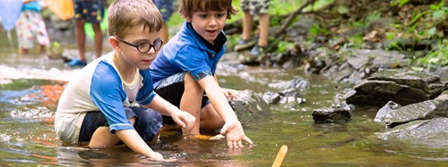 two children playing in a stream