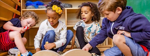 four children playing with blocks