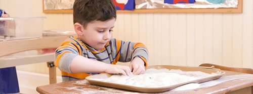 boy playing with sand