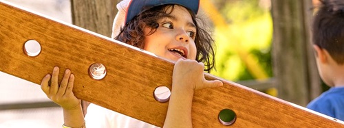child carrying a wooden board
