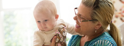 A teacher talking to a child.