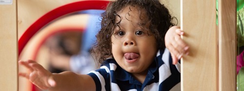 A child getting ready to slide down the Nursery Gym slide.