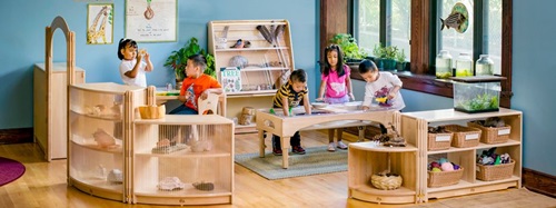Children playing in science/nature corner of a classroom