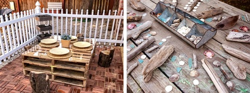 Outdoor studio with a pallet table set with plates, and a wooden table with shells and driftwood.