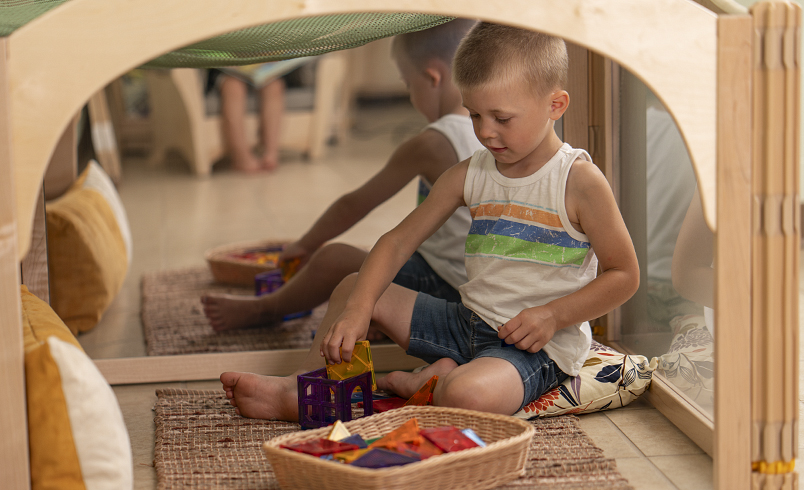 A child playing in a listening cube
