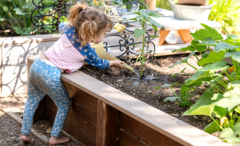 Child watering garden