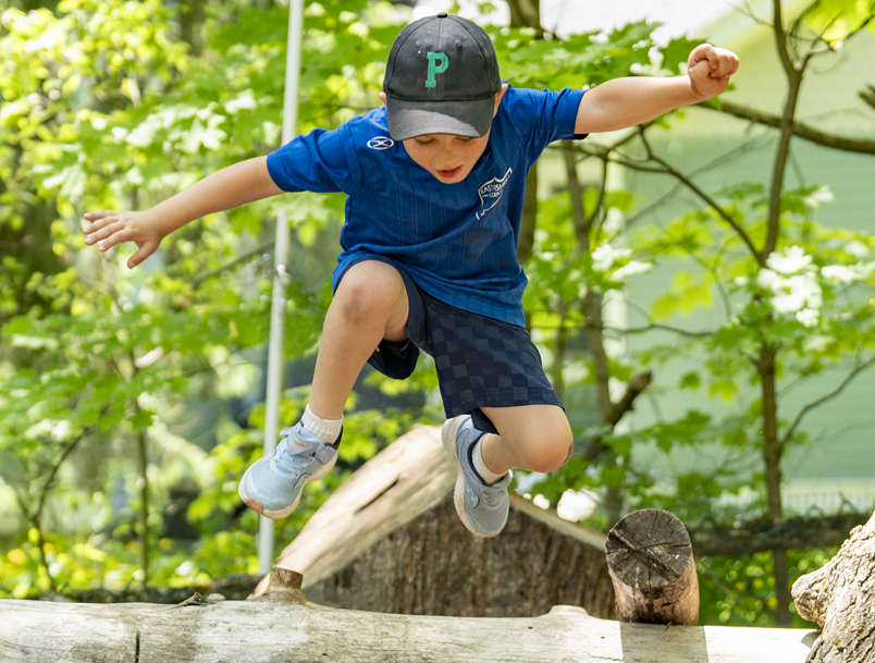 Child jumping from a log