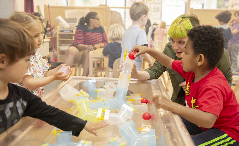 Children playing at a Community Plaything sensory table