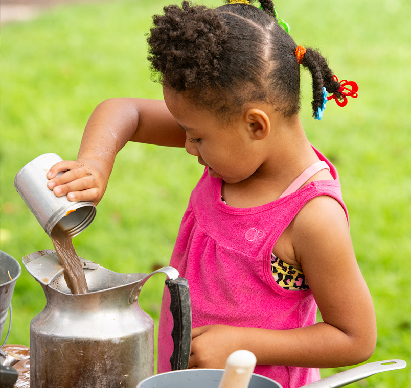 Child pouring muddy water
