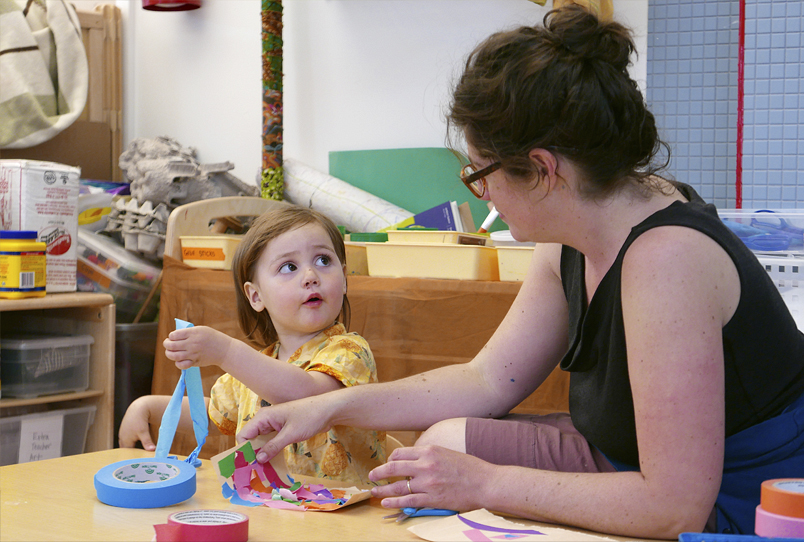 A child and teacher work on a project