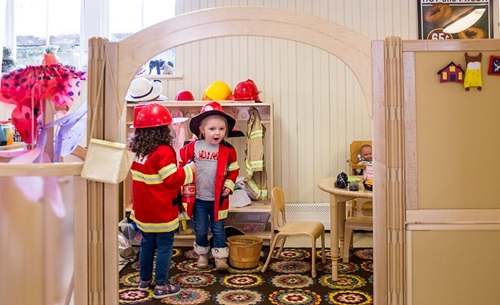 children dressing up a firefighters