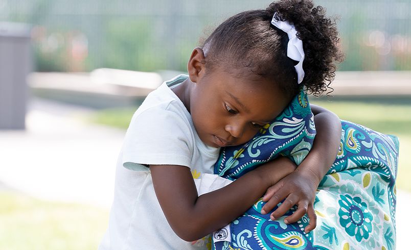 Child holding onto a blanket