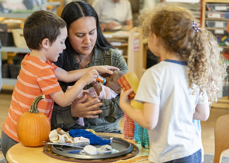 Child looking at a leaf through a transparent plastic film