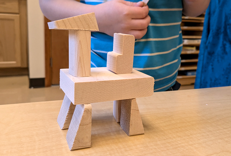 A child building a wooden craft