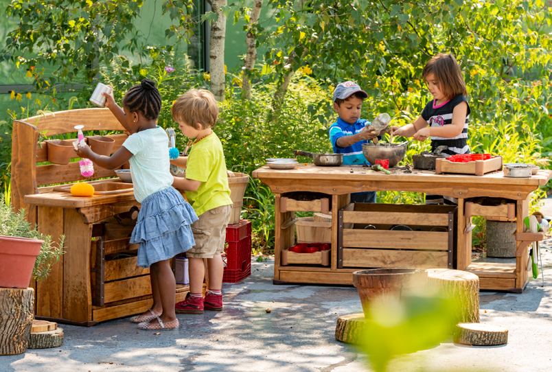 Children playing in an outdoor mud kitchen