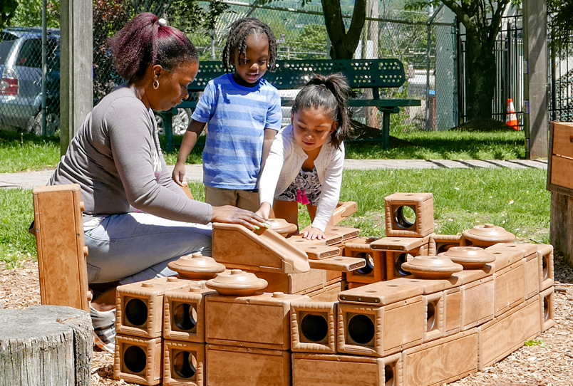 Children playing with Outlast blocks outside