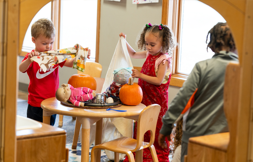 Preschool kids playing in dramatic play center