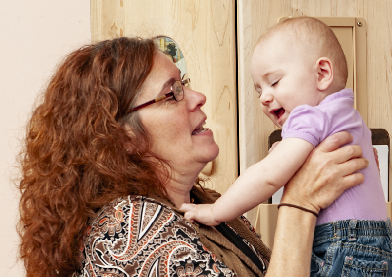 A teacher speaking to an infant.