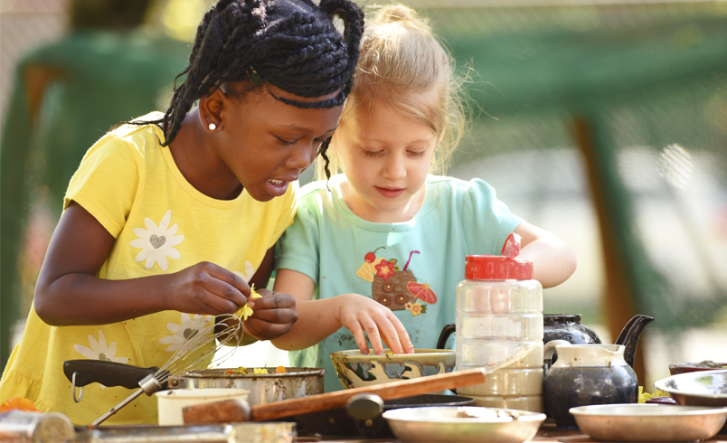 Two children playing outside on an Outlast Kitchen Counter