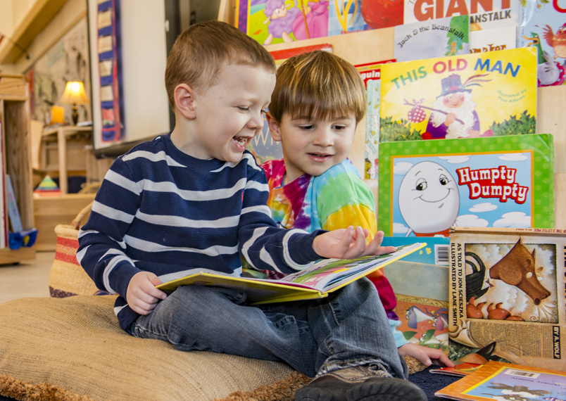 Two children looking at a book