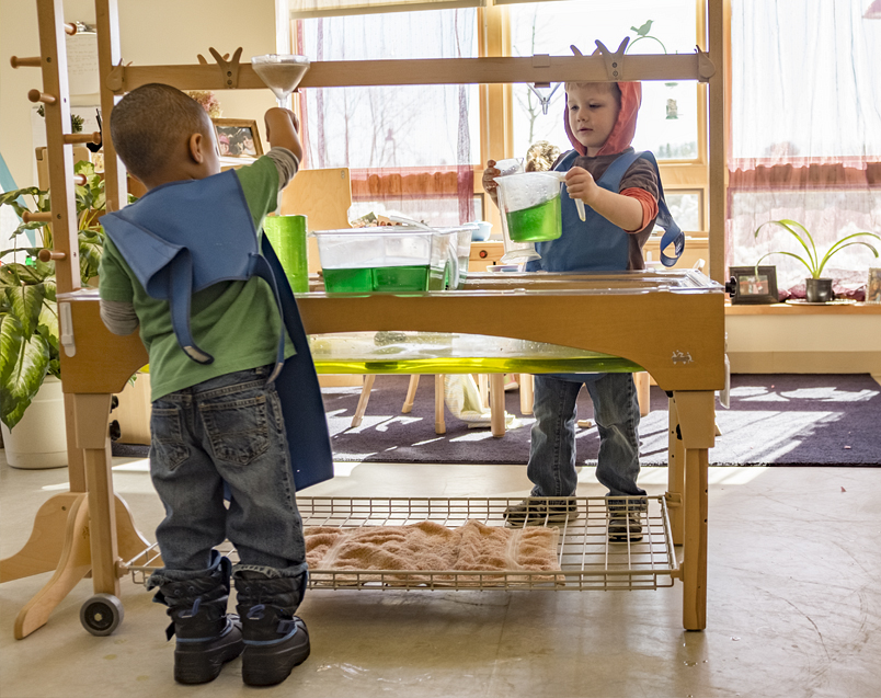 Children playing with a Community Playthings Sensory table