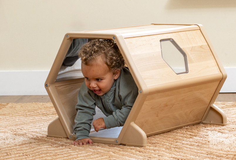 A child crawling through the Toddler Climber Tunnel