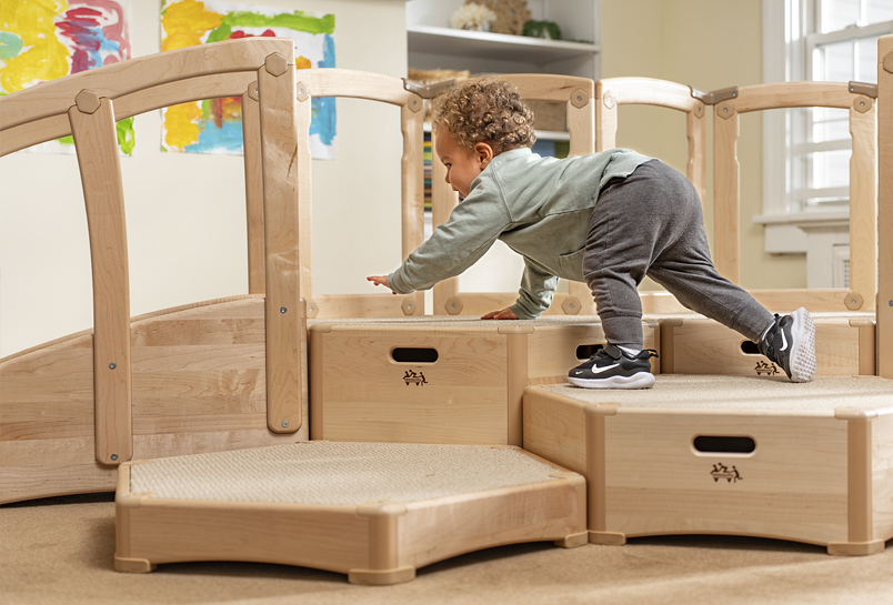 A child clambering up the large Toddler Climber