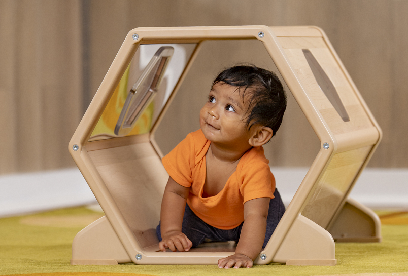 A child crawling through a Toddler Climber Tunnel