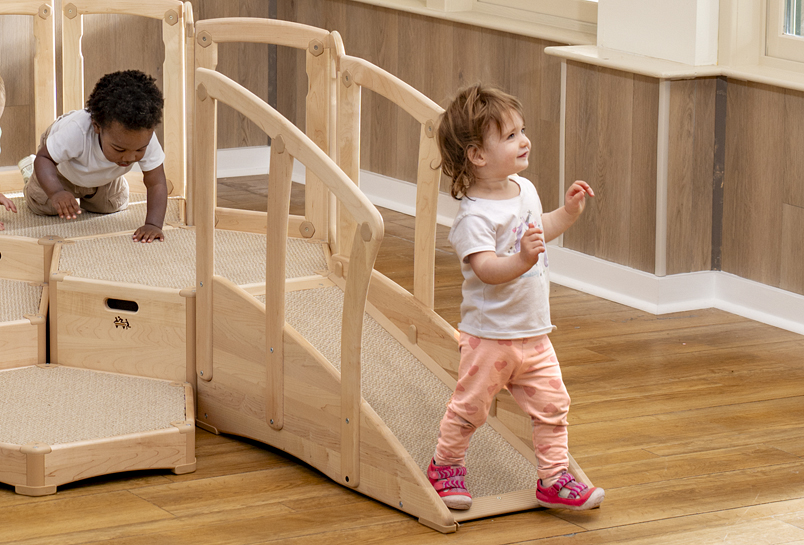 A child walking off the end of the Toddler Climber Ramp