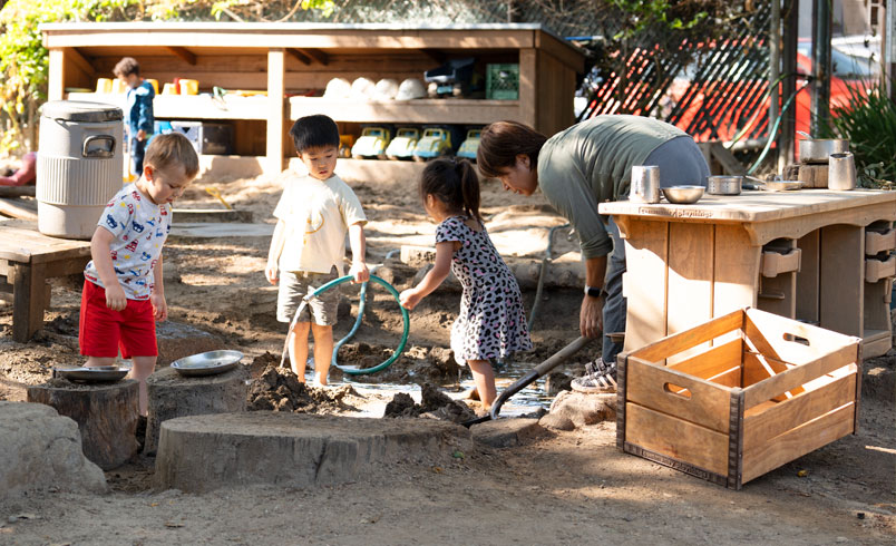 Children playing with a mud kitchen