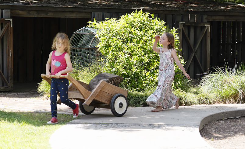 A child pulling an Outlast Wheelbarrow
