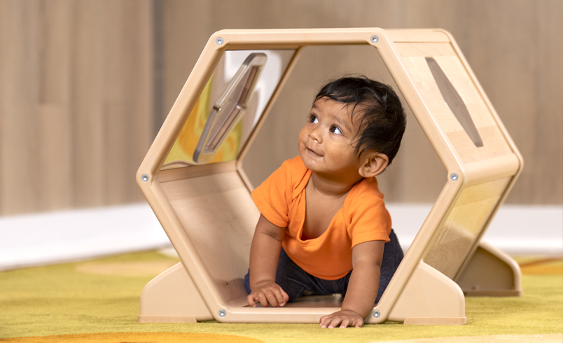 A toddler crawling through a toddler tunnel