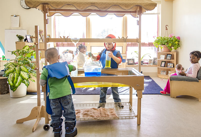 Children playing with a Community Playthings sensory table
