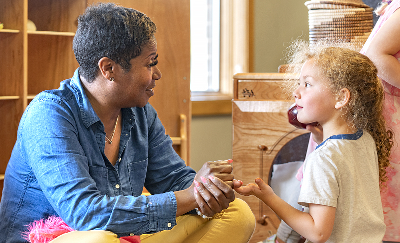 A teacher talking with a child