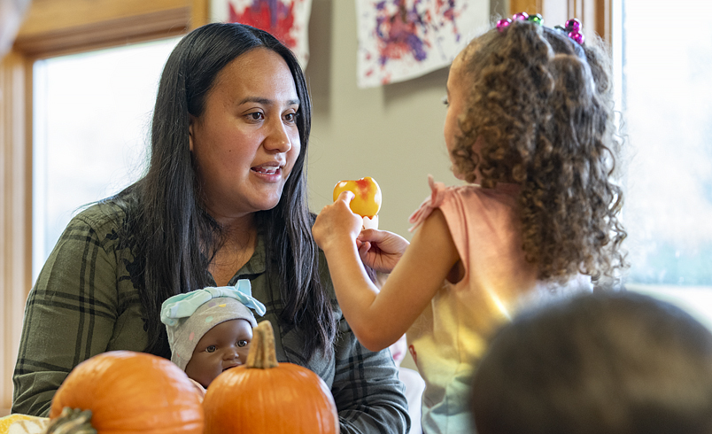 A teacher talking with a child