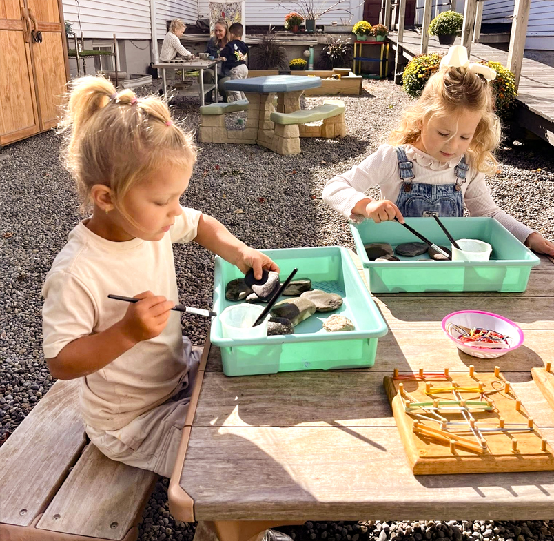 Children exploring loose parts at an Outlast Project table