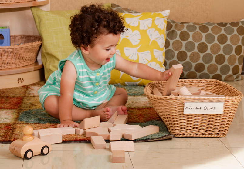 Toddler playing with mini unit blocks